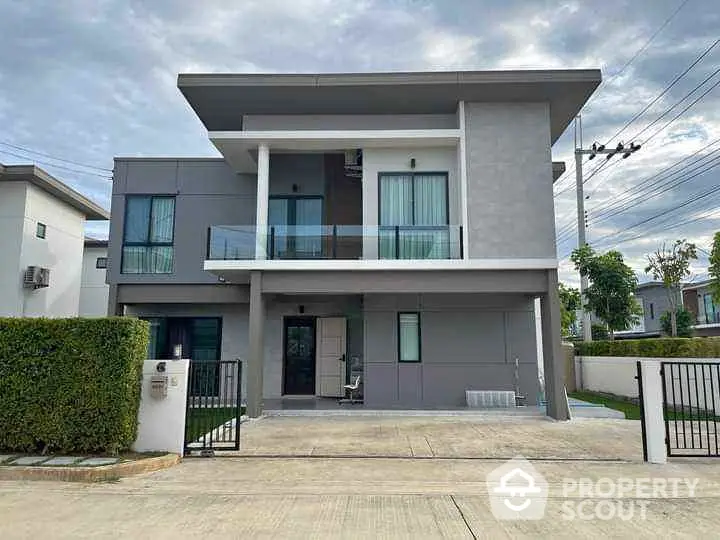 Modern two-story house with sleek design and spacious driveway in a serene neighborhood.