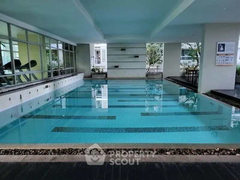 Luxurious indoor swimming pool with modern design and serene ambiance.