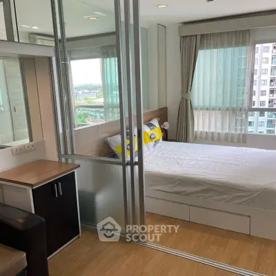 Modern bedroom with glass partition and city view in high-rise apartment