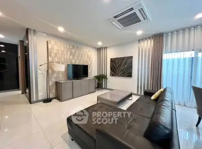 Modern living room with sleek black leather sofa and stylish decor