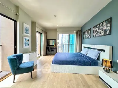 Spacious modern bedroom with balcony and city view