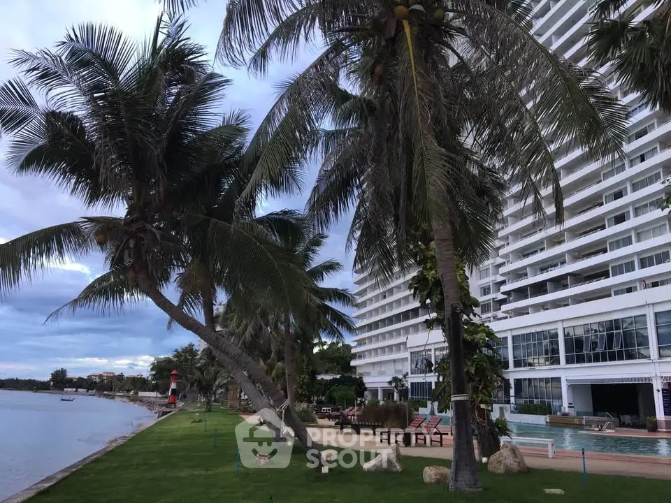 Luxurious beachfront condominium with palm trees and stunning ocean view