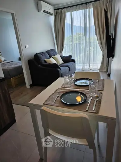 Cozy living room with dining area and scenic view, perfect for modern living.