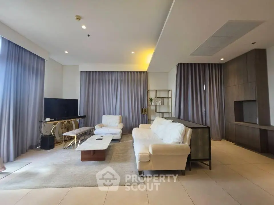Spacious modern living room with elegant furniture and large windows