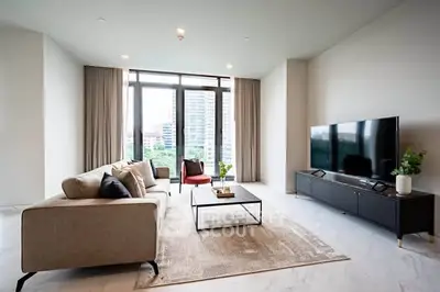 Spacious modern living room with large windows and stylish furniture in a high-rise apartment.