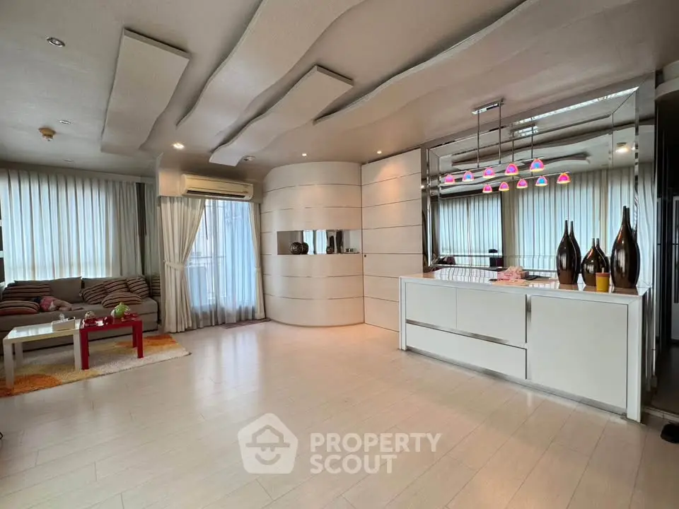 Spacious modern living room with stylish open kitchen and unique ceiling design