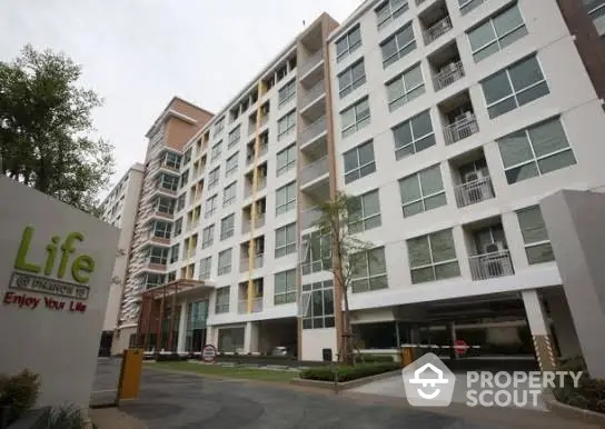 Modern apartment building exterior with spacious balconies and contemporary design.