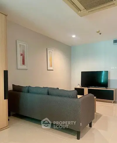 Modern living room with sleek furniture and wall art, perfect for relaxation and entertainment.
