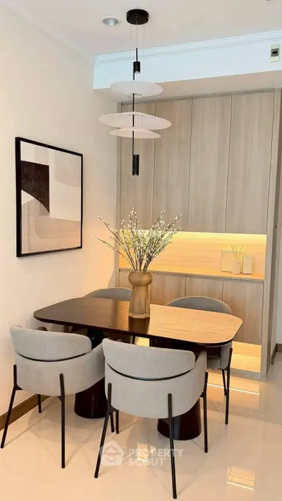Modern dining area with elegant furniture and stylish lighting in a contemporary apartment.