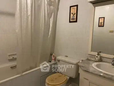 Cozy bathroom with bathtub and elegant decor, perfect for relaxation.