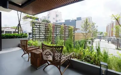 Charming balcony with lush greenery and stylish seating, perfect for relaxation.