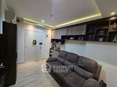 Modern living room with stylish shelving and cozy sofa in a contemporary apartment.