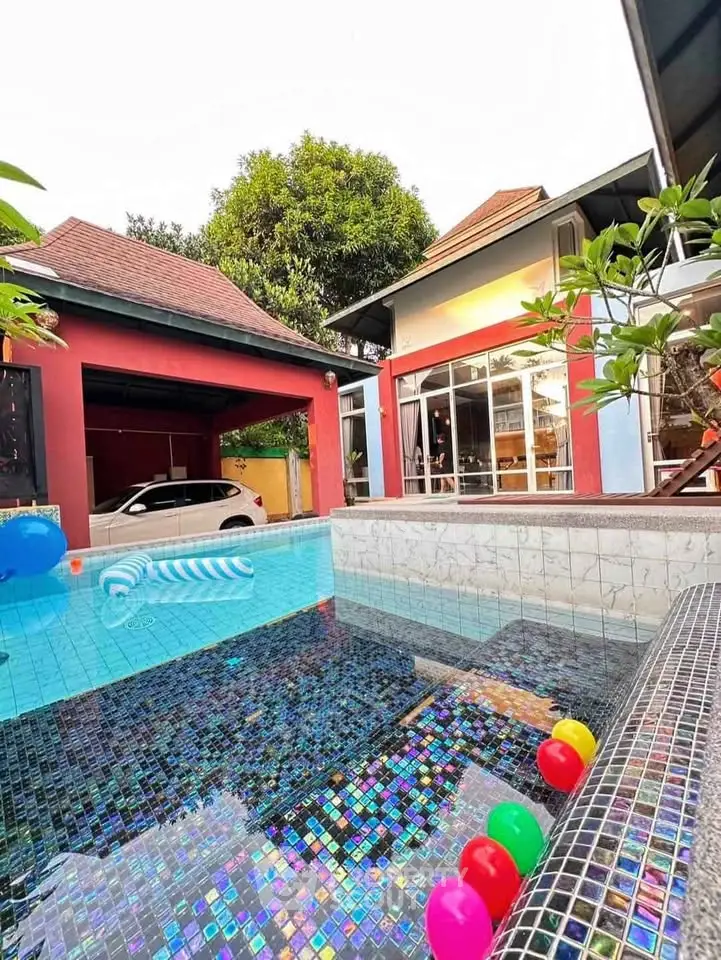 Stunning backyard pool with vibrant tiles and colorful accents in a modern home setting.