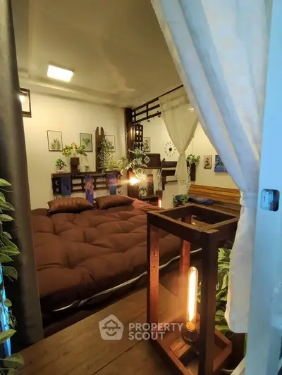 Cozy bedroom with warm lighting and stylish decor, perfect for relaxation and comfort.