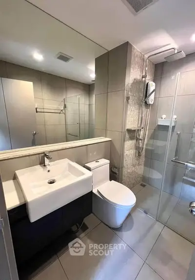 Modern bathroom with sleek fixtures and glass shower enclosure