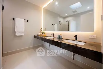 Luxurious modern bathroom with dual sinks and elegant lighting