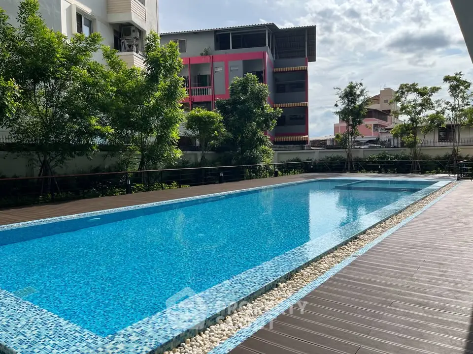 Luxurious outdoor pool area with modern design and lush greenery