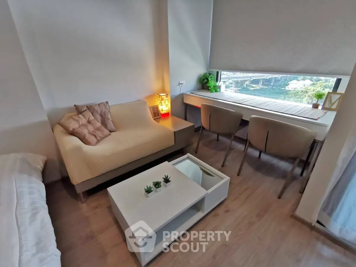 Modern living room with cozy seating and large window view