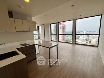 Spacious modern apartment with open kitchen and panoramic city views.