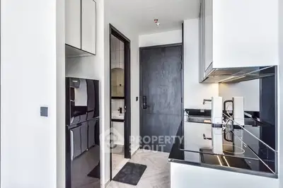 Modern kitchen with sleek black countertops and high-end appliances in a contemporary apartment.