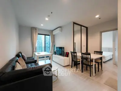 Modern living room with sleek furniture and city view from window