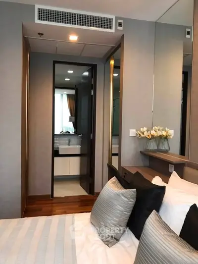 Modern bedroom with elegant decor and ensuite bathroom in luxury apartment