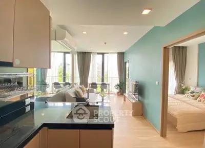 Modern open-plan living room with kitchen and balcony view