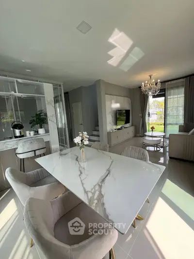 Luxurious open-plan living room with elegant dining area and modern decor