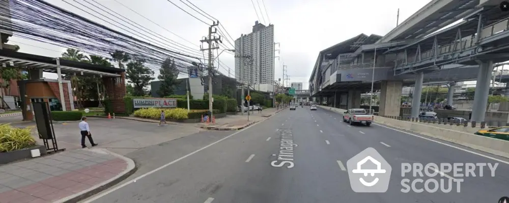 Urban street view with modern buildings and elevated train station