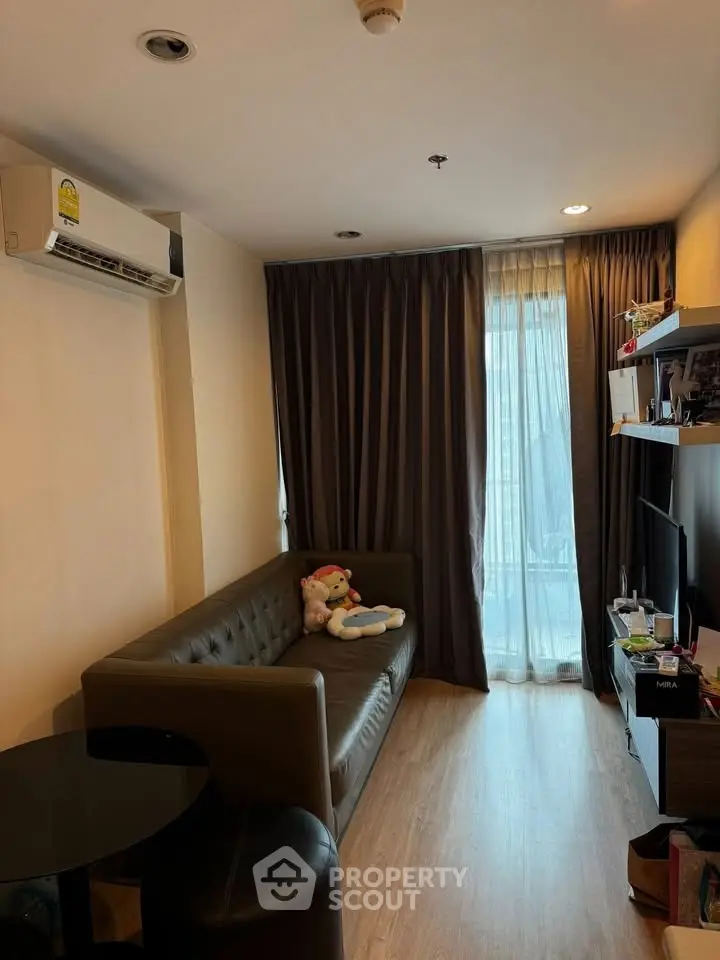 Cozy living room with modern sofa and natural light from large window