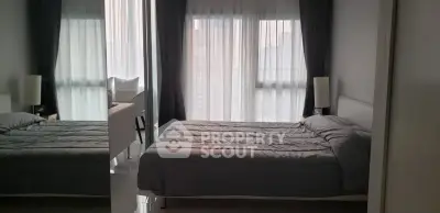 Modern bedroom with large window and stylish decor in a high-rise apartment.
