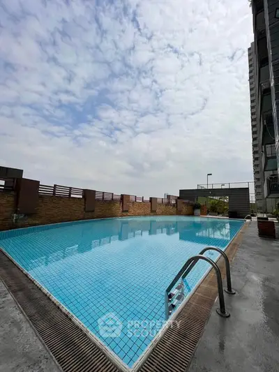 Stunning rooftop pool with clear blue water and city views, perfect for relaxation and leisure.