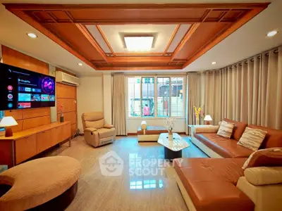 Luxurious living room with elegant wooden ceiling and modern furniture, perfect for relaxation and entertainment.