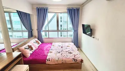 Cozy bedroom with large window and modern decor in urban apartment