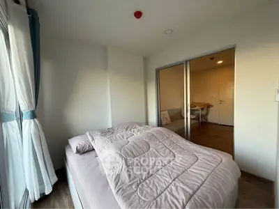 Cozy bedroom with soft lighting and modern decor, featuring a comfortable bed and stylish curtains.