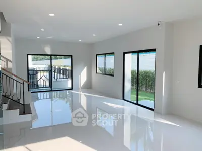Spacious modern living room with large windows and glossy floor tiles
