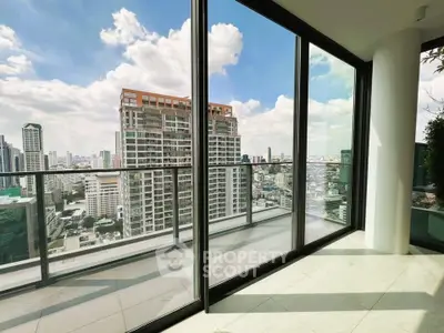 Stunning high-rise balcony with panoramic city views and modern glass railing.