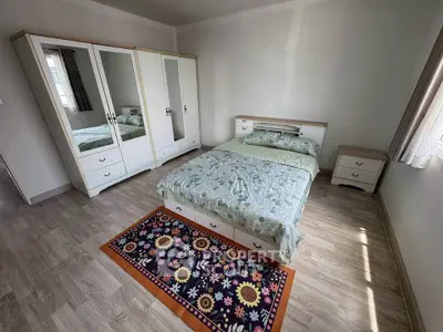 Spacious bedroom with modern furniture and natural light