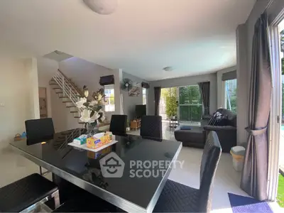 Spacious modern living room with elegant dining area and natural light