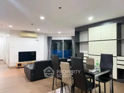 Spacious modern living room with dining area and city view, perfect for urban living.