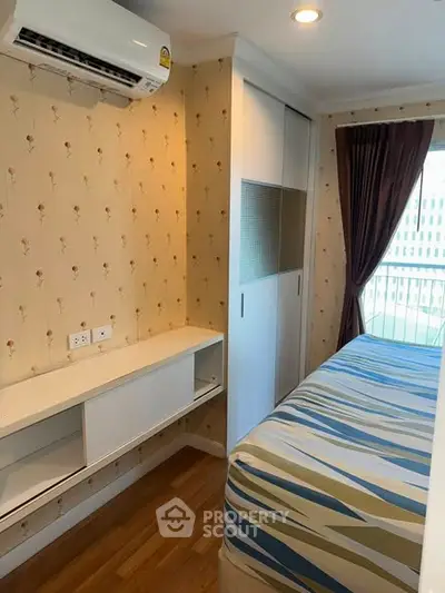 Cozy bedroom with air conditioning and balcony view in modern apartment