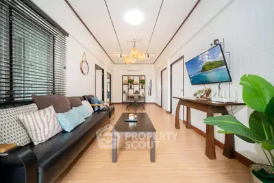 Spacious living room with modern decor and wall-mounted TV, perfect for relaxation and entertainment.
