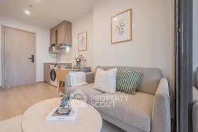 Chic modern living room with cozy sofa and compact kitchen in stylish apartment.