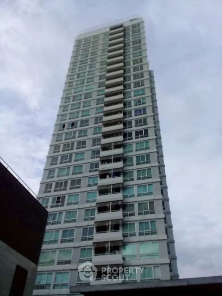 Stunning high-rise building with modern architecture and expansive windows, perfect for urban living.