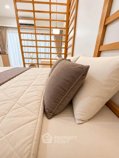 Luxurious bedroom with modern wooden accents and cozy bedding