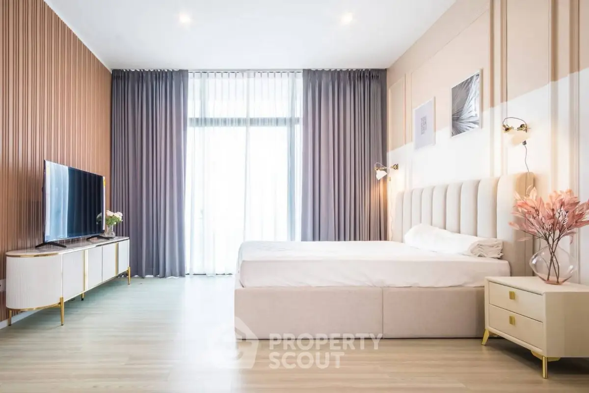 Luxurious modern bedroom with elegant decor and large windows for natural light.