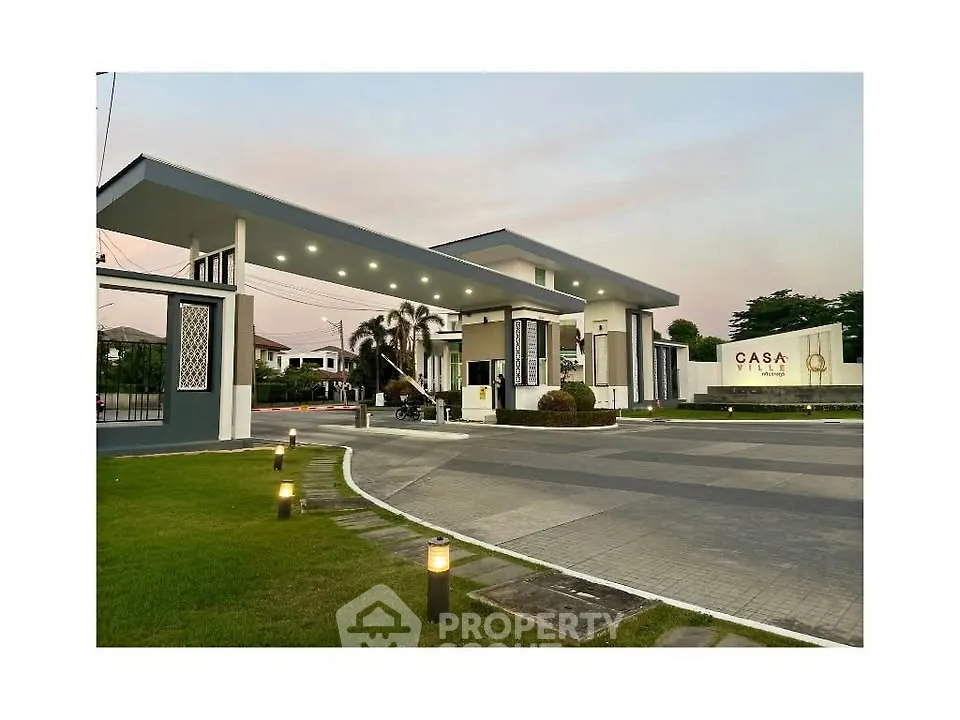 Elegant entrance of Casa Ville with modern architecture and lush greenery