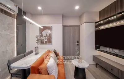 Modern living room with stylish furniture and elegant decor, featuring a cozy sofa and sleek lighting.