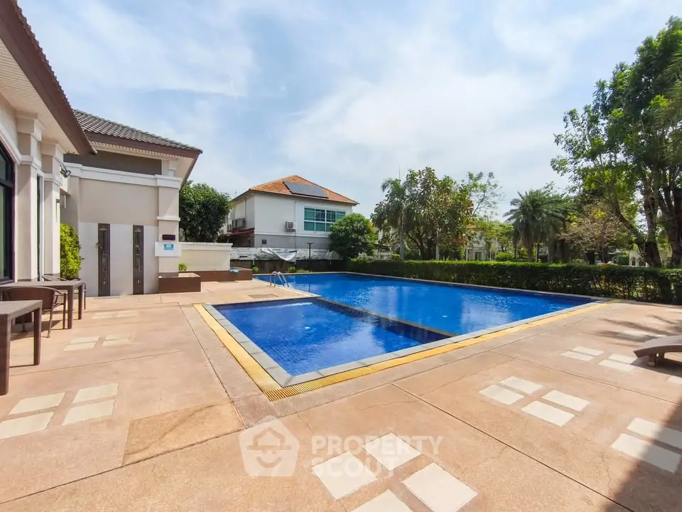 Luxurious residential pool area with modern design and lush greenery