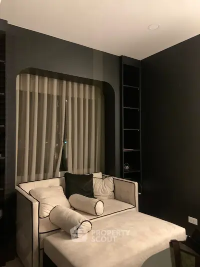 Luxurious modern living room with elegant black walls and plush seating, perfect for relaxation and style.
